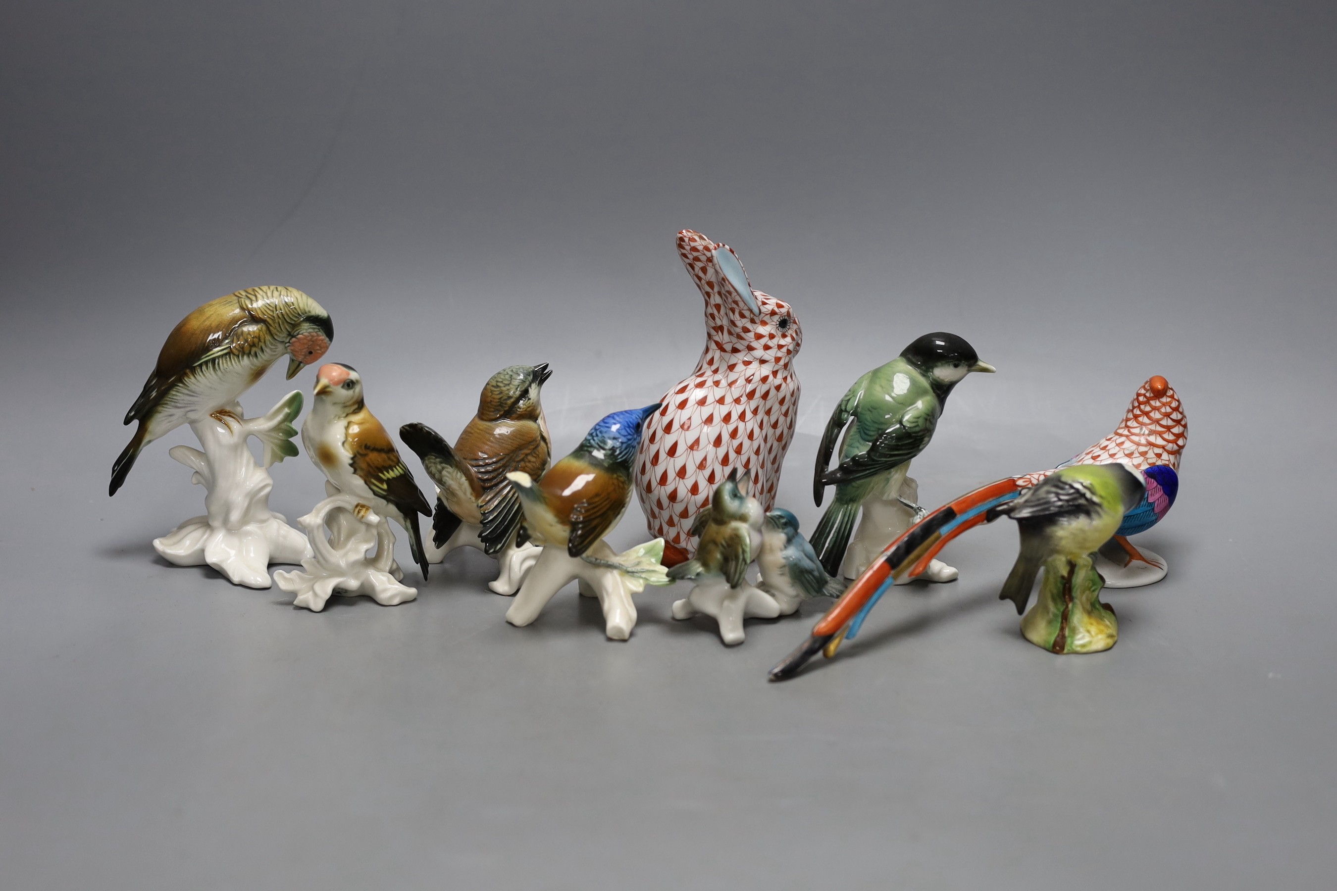 Six Karl Ens porcelain bird models, a Herend red net pattern peacock and a similar rabbit